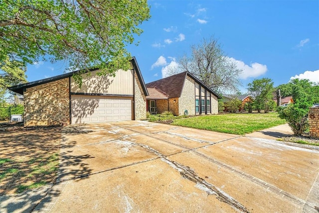 mid-century inspired home with an attached garage, a front lawn, and concrete driveway