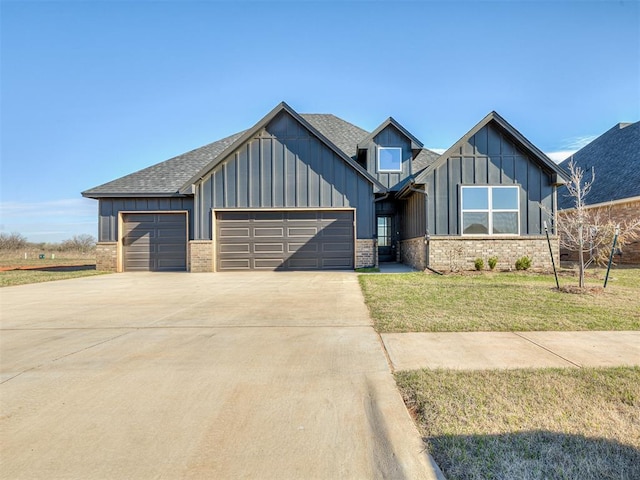 view of front of property featuring board and batten siding, a front lawn, driveway, and an attached garage