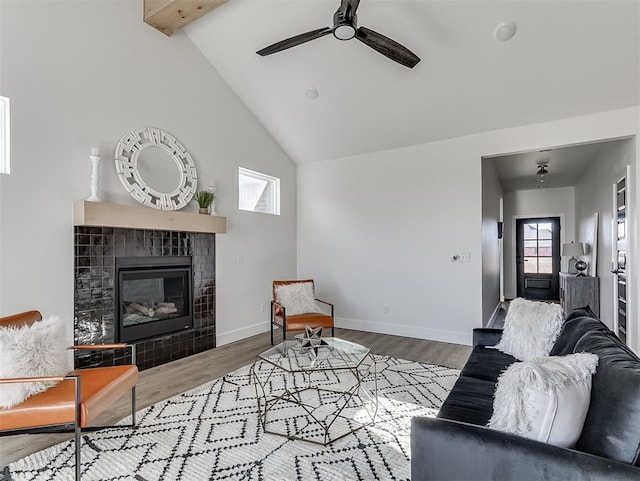 12909 NW 143rd St, Piedmont, OK 73078 - living area featuring a fireplace, wood finished floors, beamed ceiling, ceiling fan, and baseboards