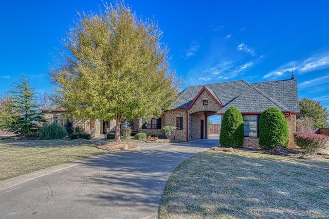 393 Haloka Ave, Washington, OK 73093 - view of front of house with driveway, a front yard, and brick siding