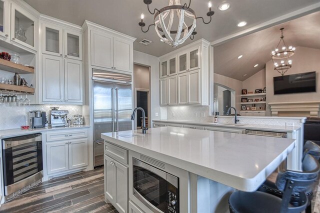 393 Haloka Ave, Washington, OK 73093 - kitchen with light countertops, wine cooler, a sink, a chandelier, and built in appliances