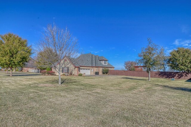 393 Haloka Ave, Washington, OK 73093 - view of yard featuring fence and a garage