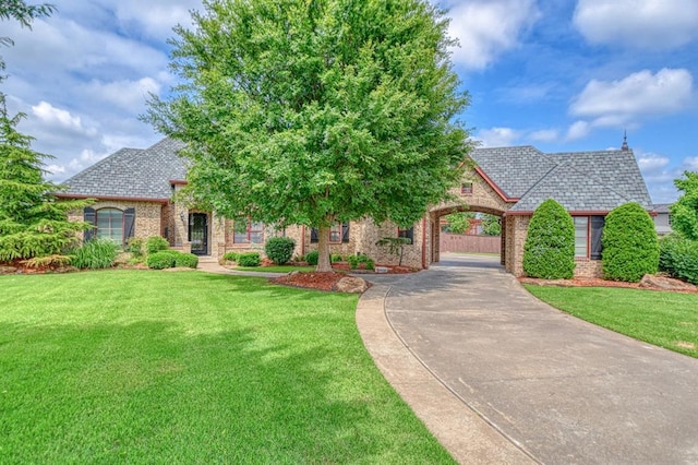 393 Haloka Ave, Washington, OK 73093 - french provincial home featuring brick siding, a front lawn, and a high end roof