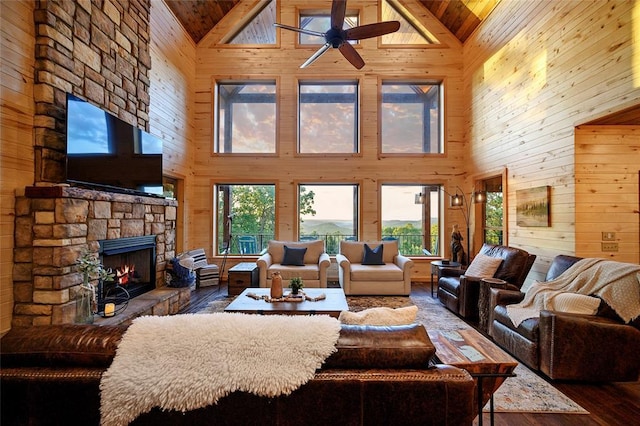 357 Little Creek Ln, Broken Bow, OK 74728 - living room featuring a ceiling fan, wooden walls, and plenty of natural light