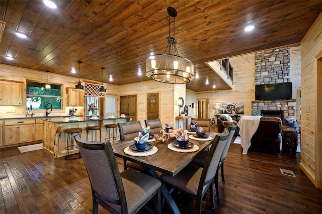 357 Little Creek Ln, Broken Bow, OK 74728 - dining area featuring dark wood-style flooring, wooden ceiling, wooden walls, and a chandelier