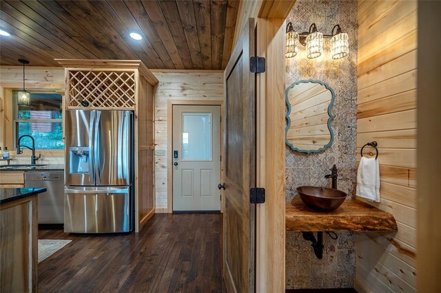 357 Little Creek Ln, Broken Bow, OK 74728 - kitchen with wood walls, dark countertops, appliances with stainless steel finishes, a sink, and wooden ceiling