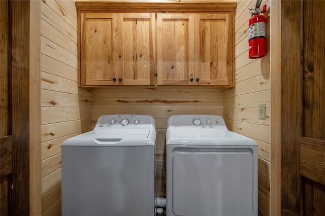 357 Little Creek Ln, Broken Bow, OK 74728 - laundry room featuring separate washer and dryer, wooden walls, and cabinet space