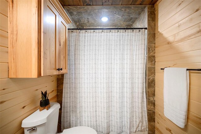 357 Little Creek Ln, Broken Bow, OK 74728 - bathroom with a shower with shower curtain, toilet, and wood walls