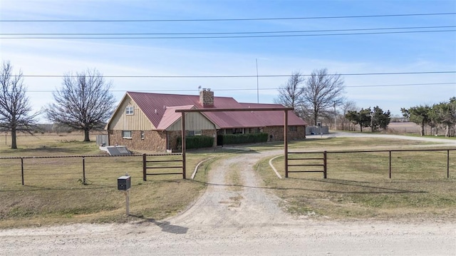 view of front of house featuring fence, a chimney, and dirt driveway