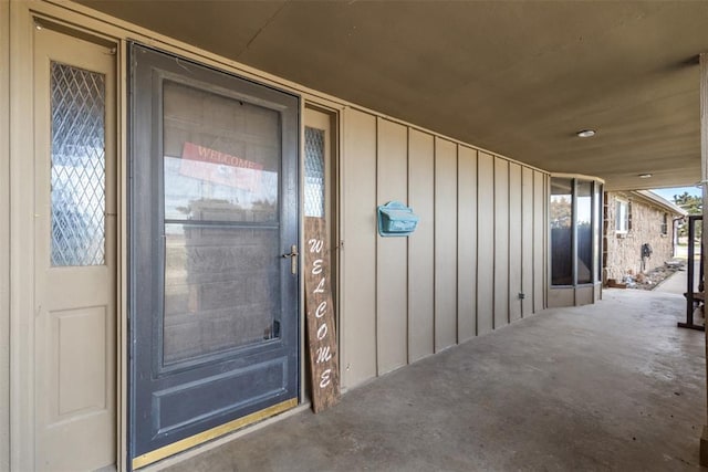 property entrance featuring board and batten siding