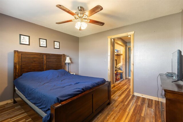 bedroom with baseboards, wood finished floors, and a ceiling fan