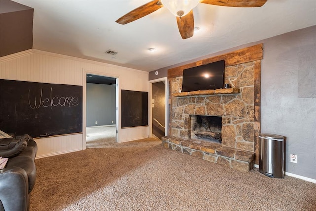 carpeted living area featuring visible vents, a fireplace, and a ceiling fan