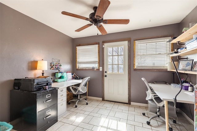 office area with light tile patterned floors, baseboards, and ceiling fan