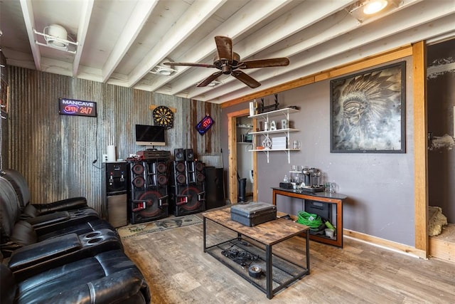 living area with a ceiling fan, beam ceiling, baseboards, and wood finished floors