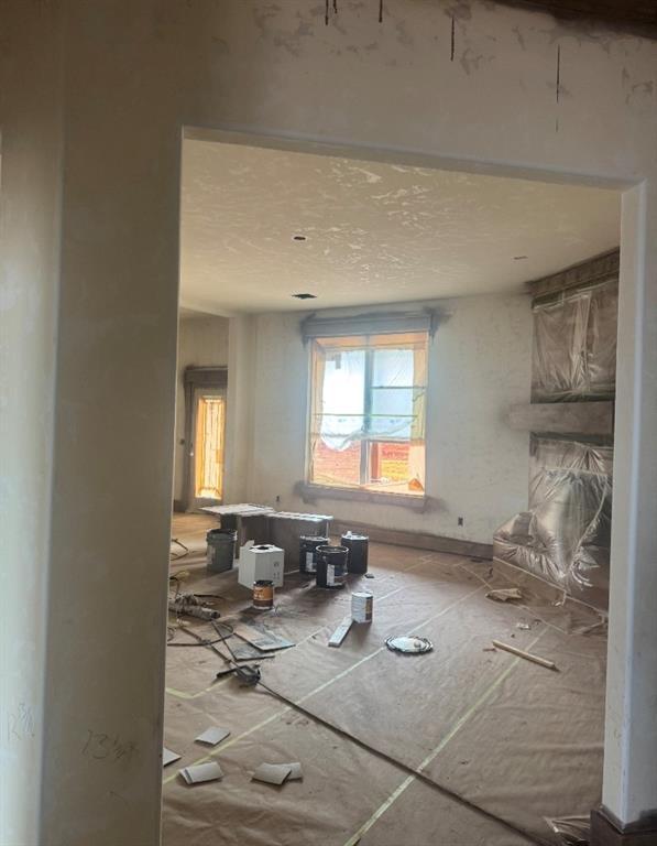 1430 County St Unit 2977, Blanchard, OK 73010 - unfurnished living room featuring a textured ceiling