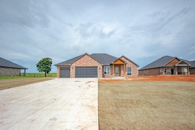 1430 County St Unit 2977, Blanchard, OK 73010 - ranch-style home featuring a garage, concrete driveway, brick siding, and a front yard