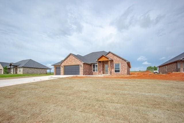 1430 County St Unit 2977, Blanchard, OK 73010 - single story home with concrete driveway, an attached garage, brick siding, and a front lawn