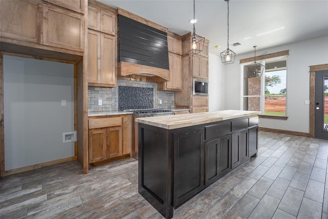 1430 County St Unit 2977, Blanchard, OK 73010 - kitchen with backsplash, wood counters, wood tiled floors, a kitchen island, and extractor fan