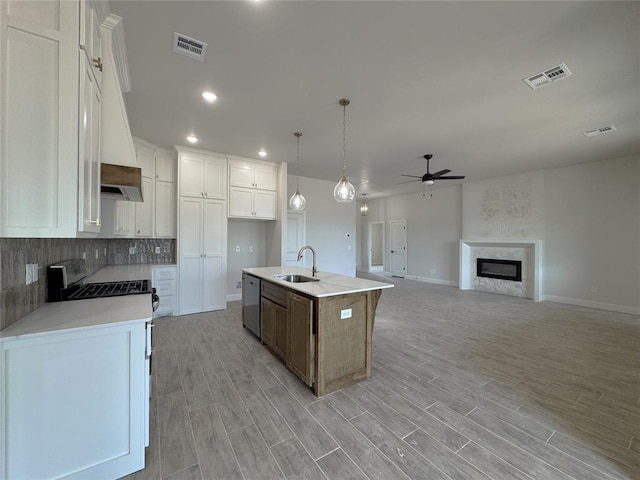 2420 Northfork Dr, Moore, OK 73160 - kitchen with a ceiling fan, a sink, white cabinetry, dishwasher, and light wood-style flooring