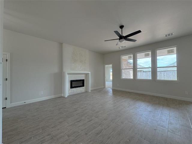 2420 Northfork Dr, Moore, OK 73160 - unfurnished living room with wood finished floors, a ceiling fan, and baseboards