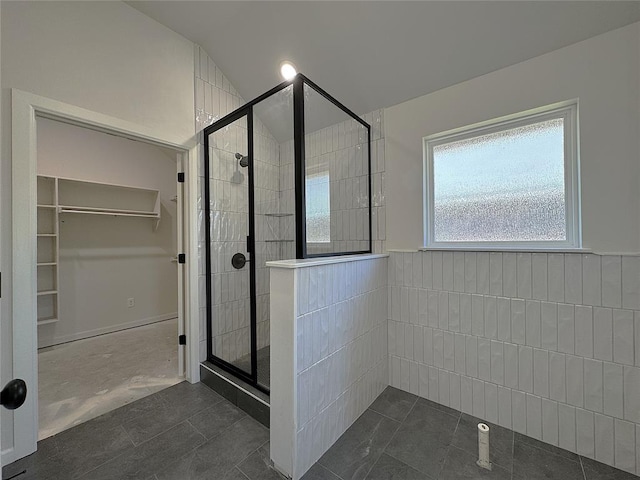 2420 Northfork Dr, Moore, OK 73160 - bathroom with a shower stall, a walk in closet, and wainscoting