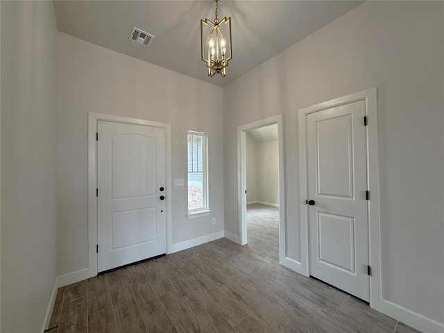 2420 Northfork Dr, Moore, OK 73160 - entrance foyer with a chandelier, baseboards, and wood finished floors