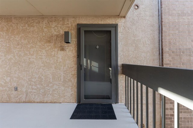 600 NW 4th St Unit 211N, Oklahoma City, OK 73102 - view of exterior entry featuring stucco siding and a balcony