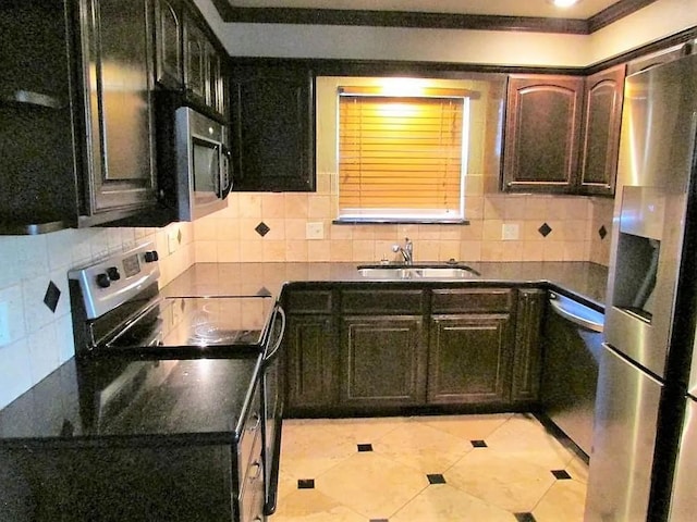 4700 NW 59th Ter, Oklahoma City, OK 73122 - kitchen featuring tasteful backsplash, a sink, and stainless steel appliances