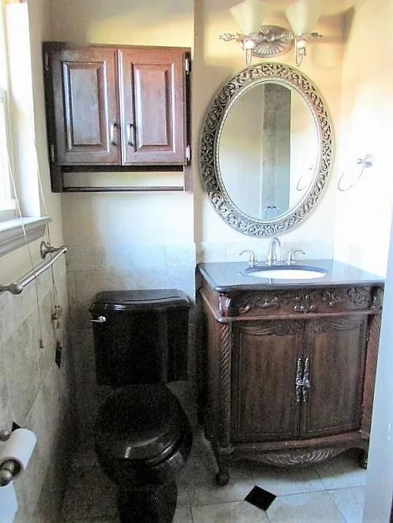 4700 NW 59th Ter, Oklahoma City, OK 73122 - bathroom featuring toilet, vanity, and tile patterned floors