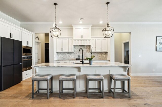 kitchen with visible vents, white cabinets, and appliances with stainless steel finishes