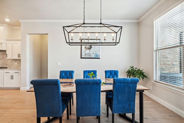 dining area featuring light wood finished floors, baseboards, ornamental molding, recessed lighting, and an inviting chandelier