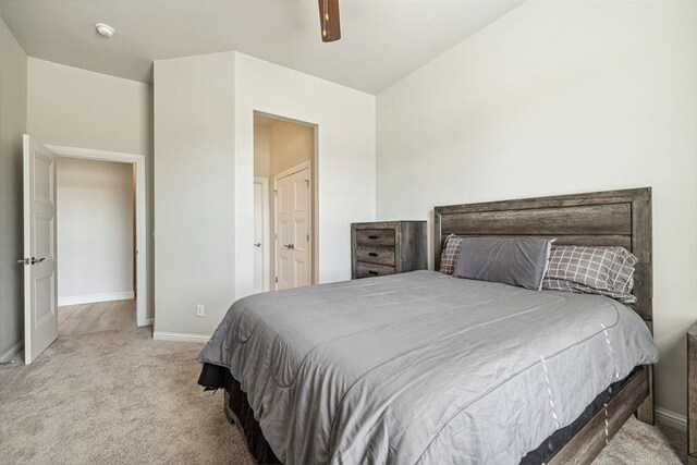 bedroom with connected bathroom, baseboards, ceiling fan, and carpet floors
