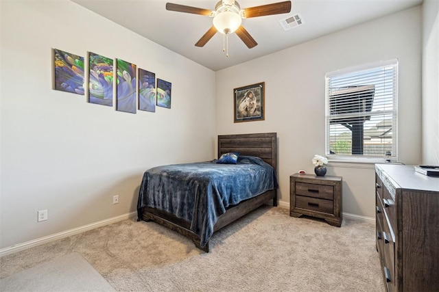 bedroom featuring baseboards, light colored carpet, and visible vents