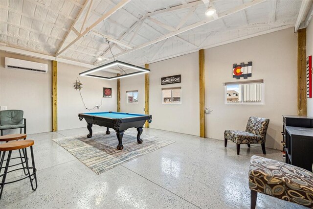 recreation room featuring a wall mounted air conditioner, speckled floor, vaulted ceiling, and billiards