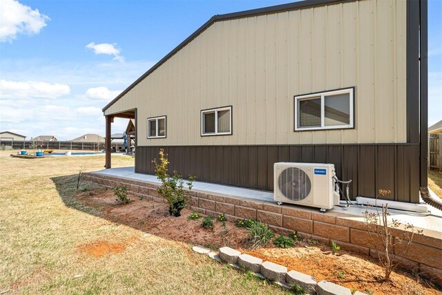 view of property exterior featuring ac unit and a lawn