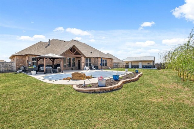 rear view of house with a patio, fence, a lawn, and a gazebo