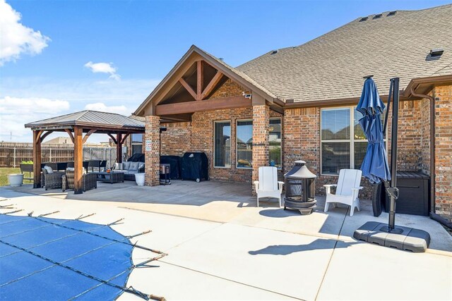 view of patio / terrace with an outdoor living space with a fire pit, area for grilling, a gazebo, and fence