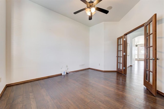 empty room with french doors, a ceiling fan, hardwood / wood-style flooring, and baseboards