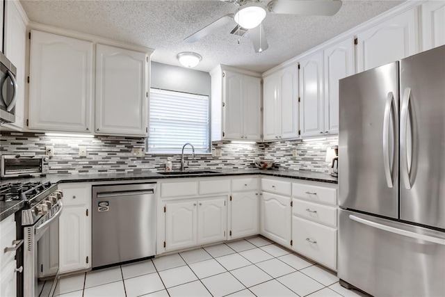 7205 N Seminole Ter, Warr Acres, OK 73132 - kitchen featuring a ceiling fan, white cabinets, a sink, stainless steel appliances, and a toaster