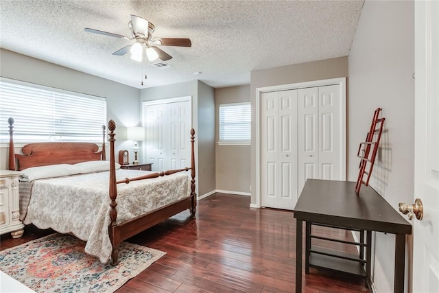 7205 N Seminole Ter, Warr Acres, OK 73132 - bedroom with ceiling fan, dark wood-type flooring, visible vents, multiple closets, and baseboards