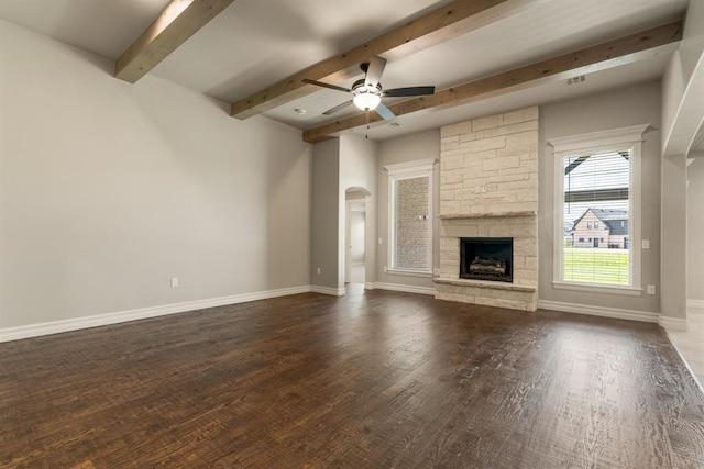 4174 Richards Way, Piedmont, OK 73078 - unfurnished living room with wood finished floors, beam ceiling, a ceiling fan, a fireplace, and arched walkways