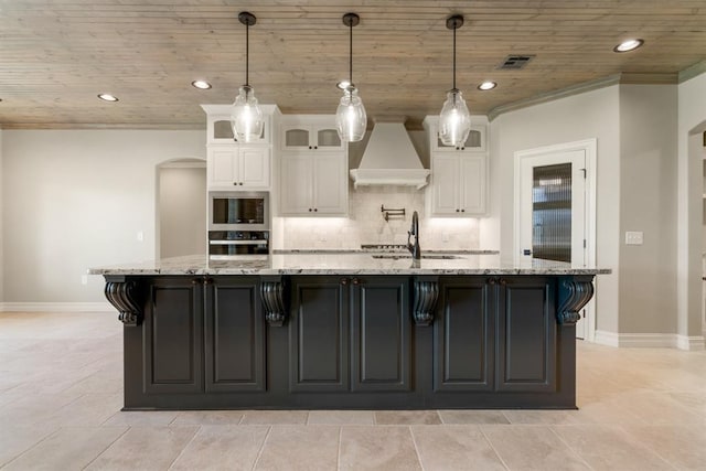 4174 Richards Way, Piedmont, OK 73078 - kitchen with custom exhaust hood, black oven, stainless steel microwave, wooden ceiling, and white cabinets