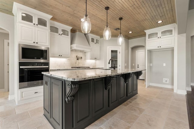4174 Richards Way, Piedmont, OK 73078 - kitchen featuring stainless steel appliances, arched walkways, custom exhaust hood, white cabinetry, and wooden ceiling