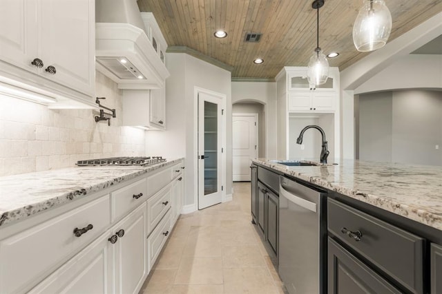 4174 Richards Way, Piedmont, OK 73078 - kitchen with arched walkways, stainless steel appliances, custom range hood, wood ceiling, and glass insert cabinets