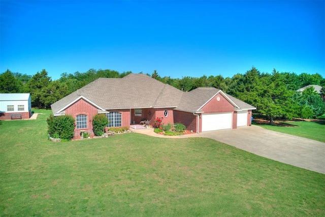 407 Heather Ln, Tuttle, OK 73089 - view of front facade featuring a garage, a front yard, driveway, and brick siding