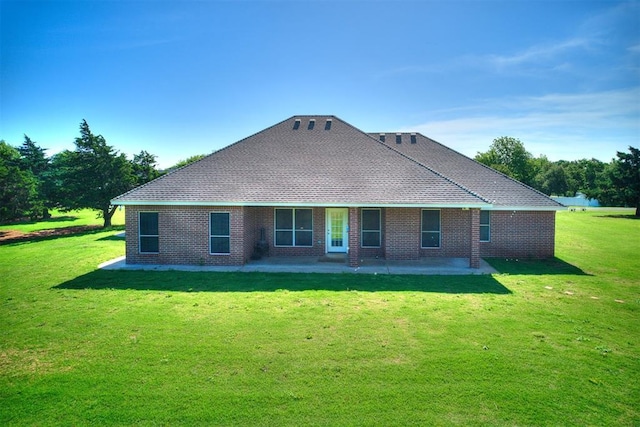 407 Heather Ln, Tuttle, OK 73089 - rear view of property with a patio area, a lawn, and brick siding