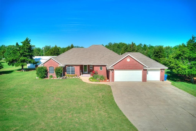 407 Heather Ln, Tuttle, OK 73089 - view of front facade featuring an attached garage, concrete driveway, a front yard, and brick siding
