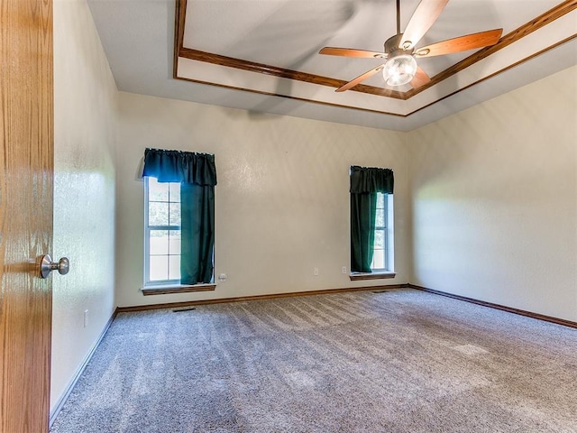 407 Heather Ln, Tuttle, OK 73089 - carpeted spare room featuring a raised ceiling, a ceiling fan, baseboards, and ornamental molding
