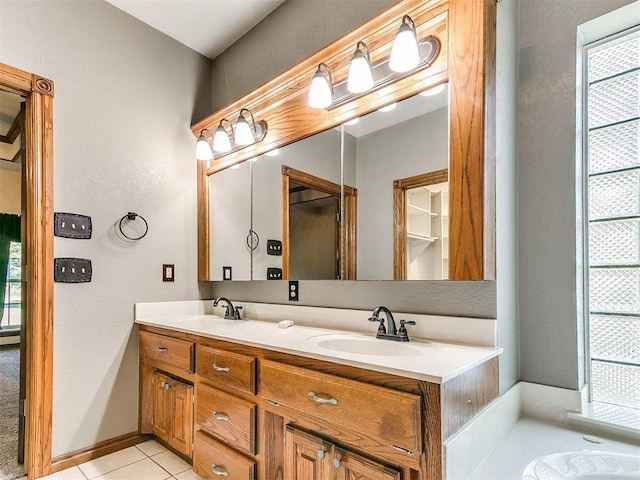 407 Heather Ln, Tuttle, OK 73089 - full bath featuring double vanity, tile patterned floors, a textured wall, and a bath
