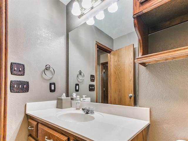 407 Heather Ln, Tuttle, OK 73089 - bathroom featuring a textured wall and vanity